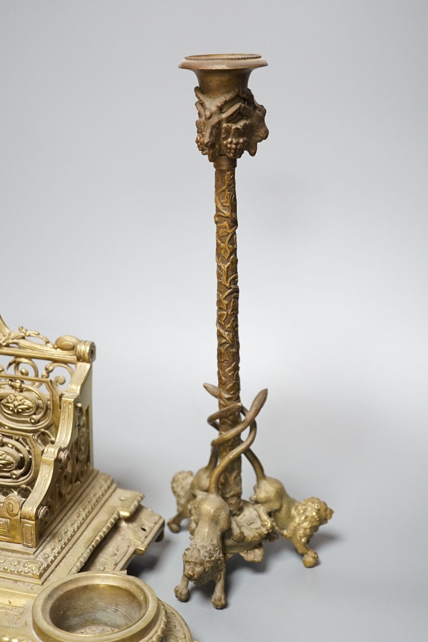 A 19th century bronze desk stand and a similar ‘rams head’ and ‘lion’ candlestick, height 33cm